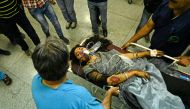 Kashmiri volunteers and medical staff move on a stretcher a girl injured on a road accident after a vehicle fell into a gorge along the Mughal road in south Kashmir’s Shopian district, at a hospital in Srinagar on June 27, 2019. AFP / Tauseef Mustafa 