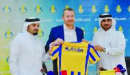 Al Gharafa SC’s new Serbian coach Slavisa Jokanovic holding a team jersey with club officials during a press conference held in Doha, yesterday.
