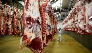 A wholesaler inspects beef carcasses that hang inside a refrigerated room at the Cibevial slaughterhouse in Corbas, France, May 4, 2016. Reuters/Robert Pratta 