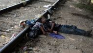 Two migrants from Guatemala sleep on train tracks in Arriaga, Mexico in August 2014 (Jorge Dan Lopez / Reuters) 