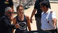 FILE PHOTO: Carola Rackete, the 31-year-old Sea-Watch 3 captain, disembarks from a Finance police boat and is escorted to a car, in Porto Empedocle, Italy July 1, 2019. REUTERS/Guglielmo Mangiapane/File Photo