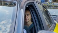German captain of humanitarian ship Sea-Watch 3 Carola Rackete looks on as she leaves in a car of the Italian Guardia di Finanza law enforcement agency on July 1, 2019 in Agrigento, Sicily (AFP/Giovanni Isolino) 