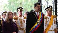 Venezuela's President Nicolas Maduro stands next to his wife Cilia Flores and Defense Minister Vladimir Padrino Lopez, as he arrives for a military parade to celebrate the 208th anniversary of Venezuela's declaration of independence in Caracas, Venezuela 