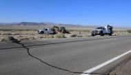 A crack on Highway 178 is seen as construction workers fix a broken water line south of Trona, after a 6.4-magnitude earthquake hit in Ridgecrest, California, on July 4, 2019. AFP / FREDERIC J. BROWN