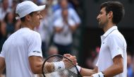 Serbia's Novak Djokovic is congratulated by Poland's Hubert Hurkacz after their men's singles third round match on the fifth day of the 2019 Wimbledon Championships at The All England Lawn Tennis Club in Wimbledon, southwest London, on July 5, 2019. AFP /