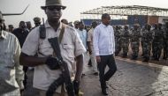 Malian Prime Minister Boubou Cisse reviews a guard of honour upon his arrival in Sevare, central Mali, on July 3, 2019. AFP / Marco Longari  