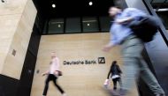 Pedestrian walk past the offices of of German bank Deutsche Bank in central London on July 8, 2019. AFP / Tolga AKMEN
