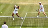 Britain's Andy Murray (R) and US player Serena Williams return against Brazil's Bruno Soares and US players Nicole Melichar during their mixed doubles third round match on day nine of the 2019 Wimbledon Championships at The All England Lawn Tennis Club in
