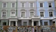 People walk past boarded-up houses ahead of the Notting Hill Carnival in London, August 27, 2016. Reuters/Neil Hall
