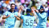 England's Chris Woakes (L) celebrates with England's Ben Stokes after dismissing Australia's Peter Handscomb for four during the 2019 Cricket World Cup second semi-final between England and Australia at Edgbaston in Birmingham, central England, on July 11