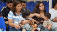 In this file photo taken on June 15, 2018 mothers and children wait to be assisted by volunteers in a humanitarian center in the border town of McAllen, Texas. AFP/Leila Macor