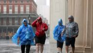 Tourists walk through rain in the French Quarter caused by Hurricane Barry in New Orleans, Louisiana, U.S. July 13, 2019. (REUTERS/Jonathan Bachman)