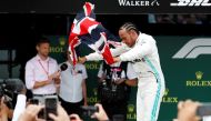 Mercedes' Lewis Hamilton waves a British flag as he celebrates winning the race (REUTERS/Matthew Childs)