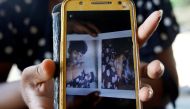 Thein Mya Yi shows a photo of Their Tun Sein, husband of Ah Hla, who died in custody, provided to the families by the prison staff, in Mrauk U, Rakhine state, Myanmar, June 29, 2019. Reuters/Ann Wang
 