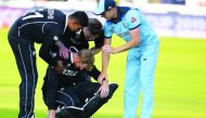 New Zealand's Martin Guptill (C) is assisted by teammates and England's Chris Woakes (R) after the 2019 Cricket World Cup final between England and New Zealand at Lord's Cricket Ground in London on July 14, 2019.  AFP / Dibyangshu Sarkar