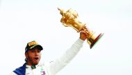  Mercedes' Lewis Hamilton celebrates with the trophy after winning the race. Reuters/John Sibley 