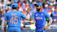 India's captain Virat Kohli (R) with Rohit Sharma during the 2019 Cricket World Cup first semi-final between New Zealand and India at Old Trafford in Manchester, northwest England, on July 10, 2019. (AFP / Dibyangshu Sarkar)