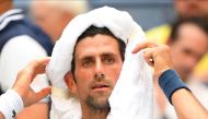 Novak Djokovic of Serbia coping with the extreme heat while playing Marton Fucsovics of Hungary in a 2018 match. Credit: Robert Deutsch-USA TODAY Sports