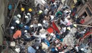 Rescue workers and residents search for survivors at the site of a collapsed building in Mumbai, India, July 16, 2019. REUTERS/Stringer 