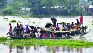 Villagers travel on a boat in the flood affected Jhargaon village in Morigaon district of India's Assam state on July 15, 2019.  AFP / Biju Boro