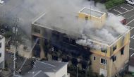 Firefighters battling fires at the site where a man started a fire after spraying a liquid at a three-story studio of Kyoto Animation Co. in Kyoto, western Japan, in this photo taken by Kyodo, July 18, 2019. Credit: Kyodo/via Reuters