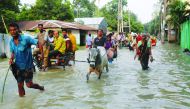 People move along a flooded road in Gaibandha, Bangladesh July 18, 2019. Reuters