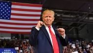  In this file photo taken on July 17, 2019 US President Donald Trump pumps his fists as he arrives for a 