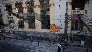 Firefighters look at a damaged abandoned building following an earthquake, in Piraeus, near Athens, Greece, July 19, 2019. Reuters/Alkis Konstantinidis