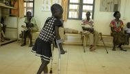 A 5-year-old girl walks with the use of a new prosthetic limb at the physical rehabilitation centre run by the International Committee of the Red Cross in Juba on March 12, 2019. AFP/Simon Maina