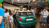 Alfardan Automobiles officials, mediapersons, and MINI car enthusiasts at the unveiling ceremony of the ‘MINI  60 Years Limited Edition’ car models in Doha. 
