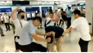 Men in white t-shirts and face masks attack anti-extradition bill demonstrators and reporters at a train station in Hong Kong, China, July 21, 2019, in this still image obtained from a social media live video. (Courtesy of Stand News/Social Media via REUT