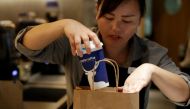 File photo of a barista packing a coffee for online sales at a Luckin Coffee store in Beijing, China July 17, 2018. REUTERS/Jason Lee/File Photo