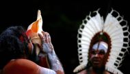 An Australian Aboriginal man blows into a shell during a welcoming ceremony at Government House in Sydney, Australia, June 28, 2017. Reuters/David Gray