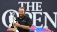 Ireland's Shane Lowry poses with the Claret Jug, the trophy for the Champion golfer of the year after winning the British Open golf Championships at Royal Portrush golf club in Northern Ireland on July 21, 2019. AFP / Glyn Kirk 