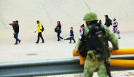 A member of the Mexican National Guard observes a group of migrants that crossed into El Paso, Texas, U.S., as seen from Ciudad Juarez, Mexico July 22, 2019. Reuters/Jose Luis Gonzalez