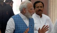 India Prime Minister Narendra Modi gestures while talking with Parliamentary Affairs Minister and Junior Foreign Minister V. Muraleedharan (R) prior to a Bhartiya Janata Party (BJP) Parliamentary Committee meeting at the Parliament house in New Delhi on J