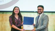 Jibin Koshy (right), Educational Enrichment Manager at GU-Q,  with GPS participant Hanah Shokeir, a year-12 student at Doha College, at the closing ceremony.