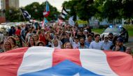 FILE PHOTO: People march in protest in San Juan on against the next in line for Puerto Rico's governor, Wanda Vazquez, Puerto Rico's current Secretary of Justice. AFP / Ricardo ARDUENGO
