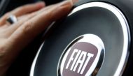 FILE PHOTO: The logo of Italian carmaker Fiat is seen on a steering wheel as a woman drives her car in Bordeaux, France, January 1, 2017. REUTERS/Regis Duvignau