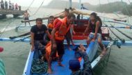 Fishermen carrying a dead body of a victim after a boat accident that happened in Iloilo-Guimaras Strait. 