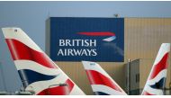 FILE PHOTO: British Airways logos are seen on tail fins at Heathrow Airport in west London, Britain, February 23, 2018. REUTERS/Hannah McKay