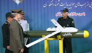 A handout picture released by Iran's Defence Ministry on August 6, 2019 shows Defence Minister Brigadier General Amir Hatami (L, front) standing by the missile 