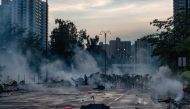 Protesters react after police fired tear gas in Tai Po district during a general strike in Hong Kong on August 5, 2019, as simultaneous rallies were held across seven districts.  AFP / Philip FONG