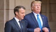 FILE PHOTO: French President Emmanuel Macron speaks with U.S. President Donald Trump (Ludovic Marin/Pool via REUTERS)