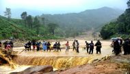 People walk through flood waters after a landslide in Meppadi, Wayanad district, in the Indian state of Kerala on August 9, 2019. (AFP)