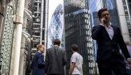 Businessmen speak in the street in the City of London on August 9, 2019. (AFP / Tolga Akmen)