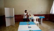 A Staff member of Guatemala's Supreme Electoral Tribunal (TSE) sets up voting equipment ahead of the second round run-off vote, in Guatemala City, Guatemala August 10, 2019. REUTERS/Jose Cabezas
