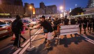 Protesters move barricades to block the entrance to the Cross-Harbour Tunnel after taking part in a rally against a controversial extradition bill in Hong Kong on August 10, 2019.  AFP / VIVEK PRAKASH