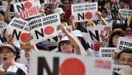 This file photo taken on August 3, 2019 shows protesters holding up placards reading 