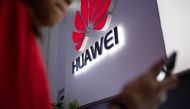 FILE PHOTO: Huawei logo is displayed at a retail store in Beijing.  AFP / FRED DUFOUR
